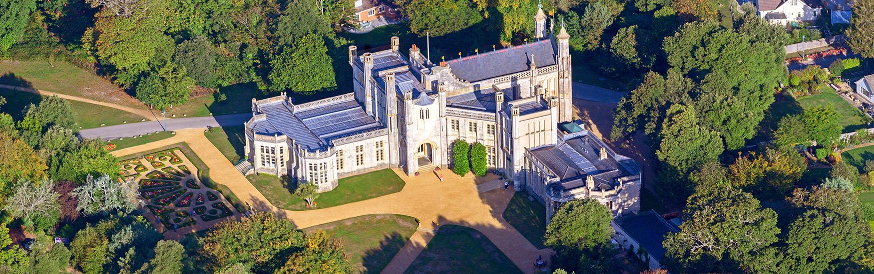 Stunning aerial shot of Highcliffe castle illuminated by the warm sun