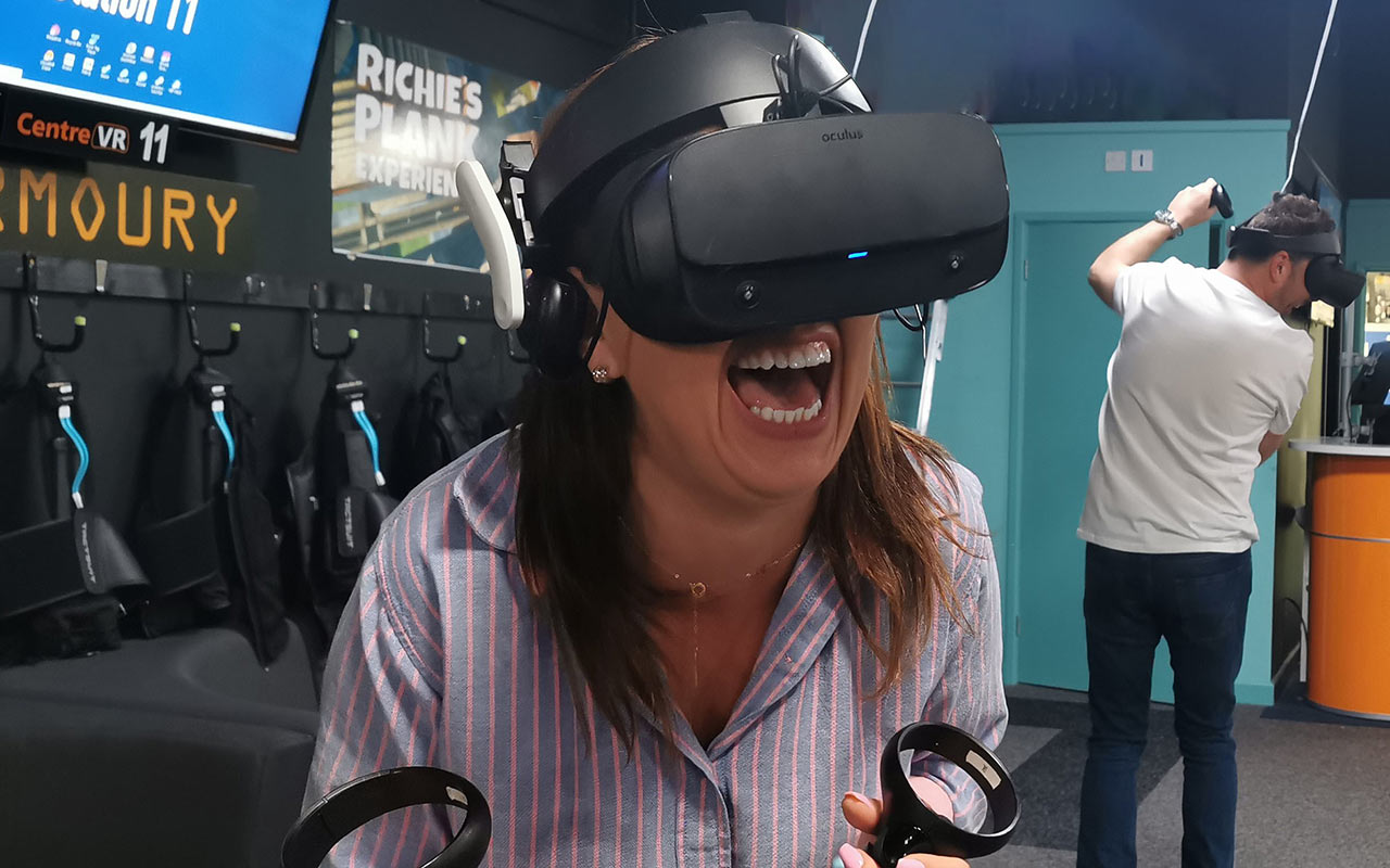 Woman laughing whilst wearing a VR headset at Centre VR in Bournemouth 