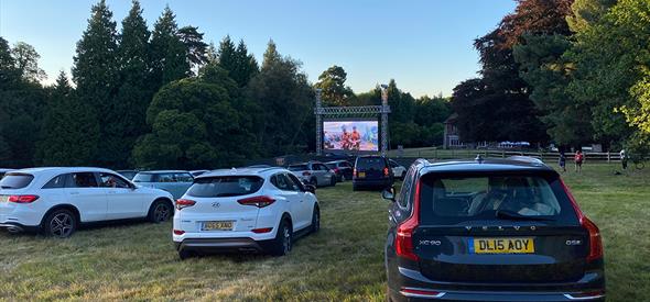 Row or cars outdoor watching a cinema screen