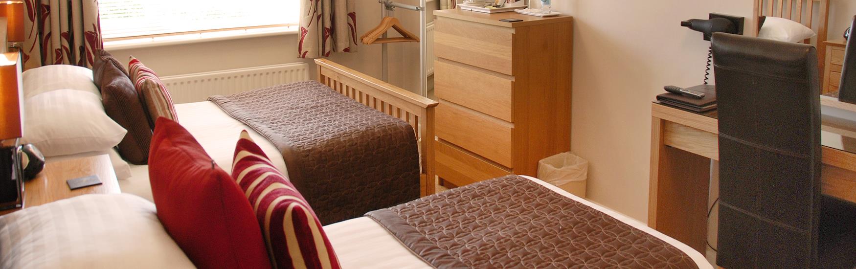 Two cosy double beds ready for guests to get comfortable at a Bed and breakfast