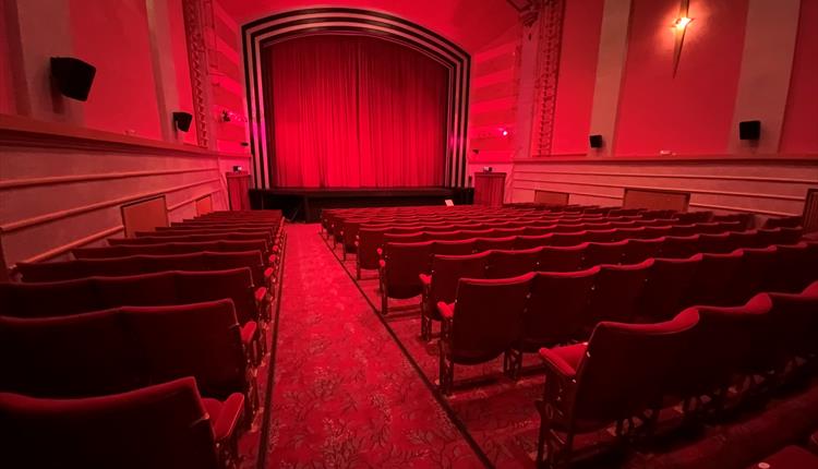 Inside the screen room with red deco red carpet and red seating