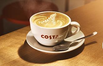 cup of costa coffee on a wooden bench.