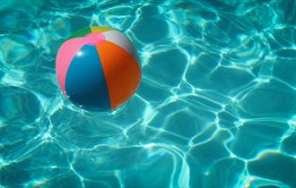 Inflatable ball floating in clear water.