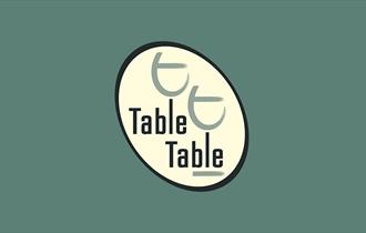 table table logo on green background.