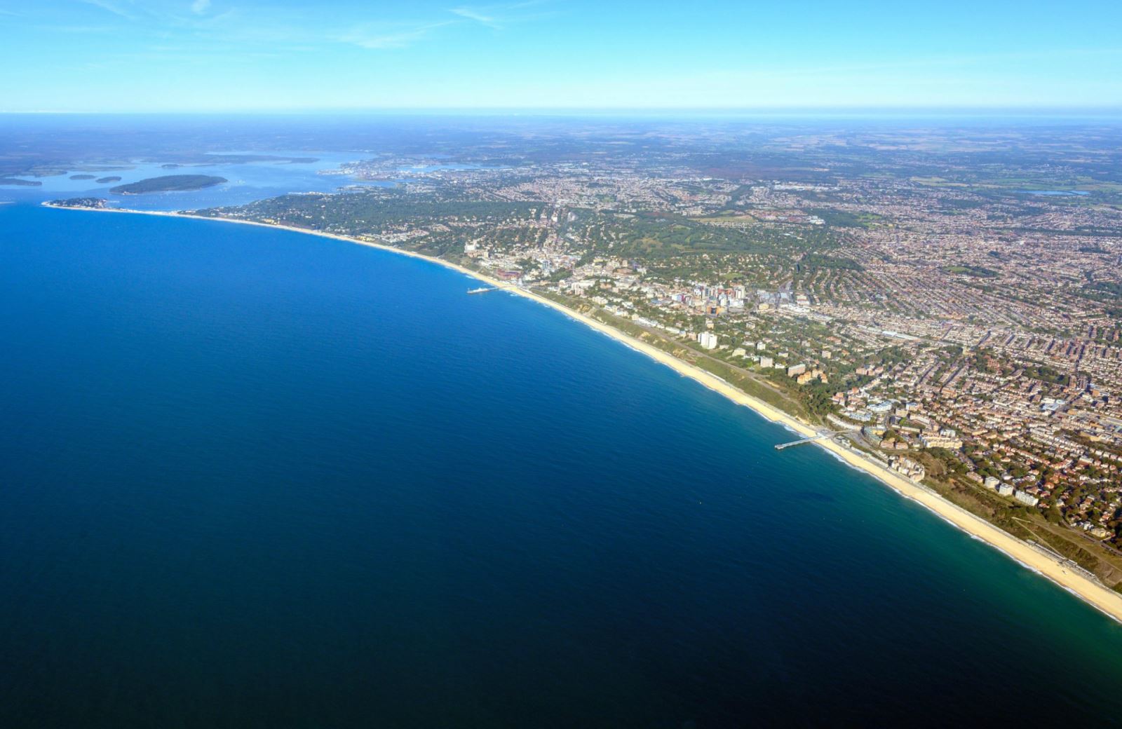 an aerial view of Bournemouth beach, with beautiful blue skies covering the resort