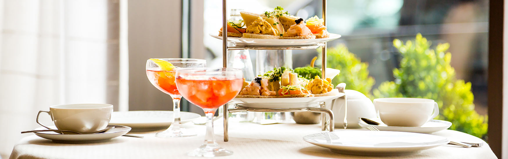 Afternoon tea set out on dining table 