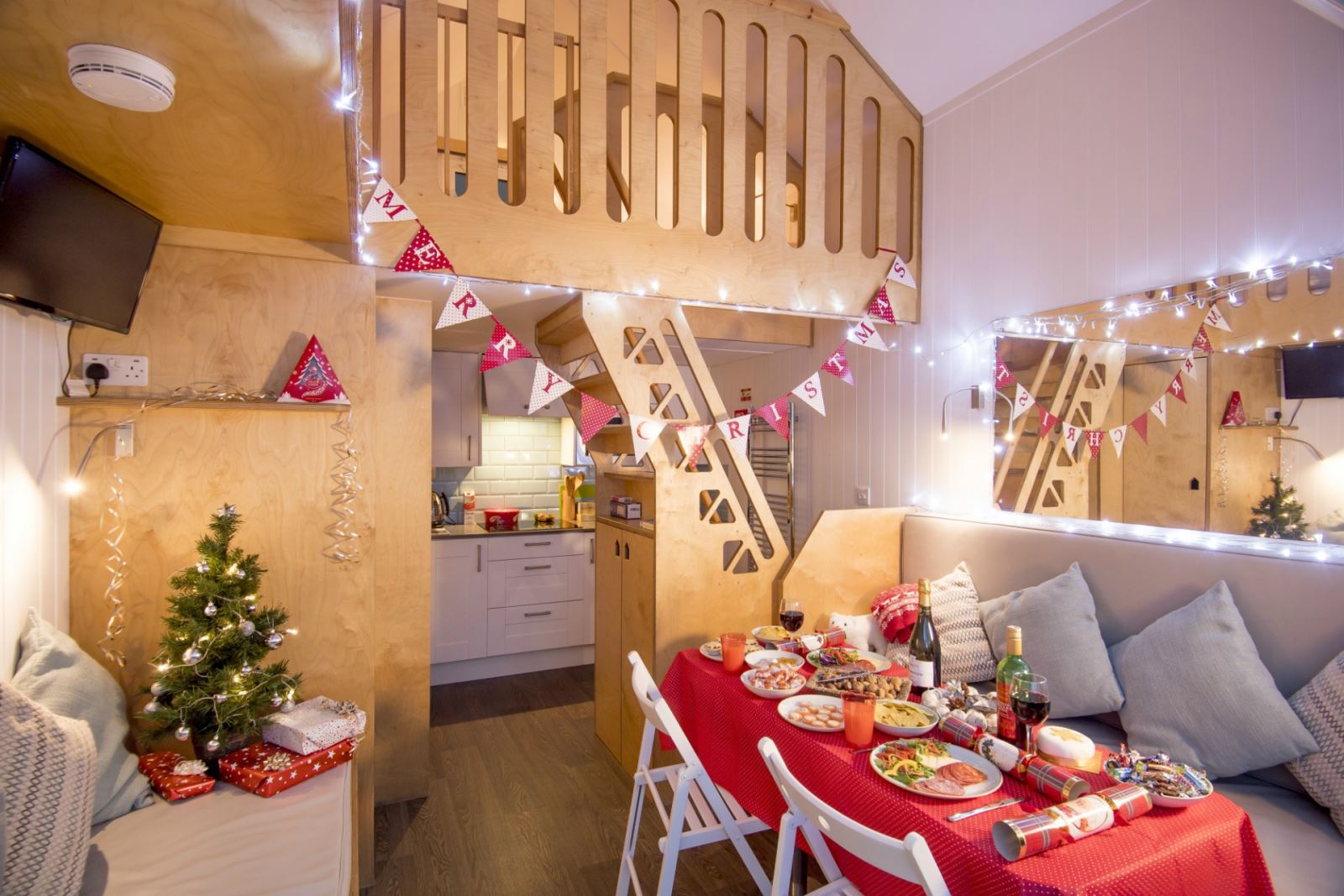 A view inside the Bournemouth beach lodges, with the interior bedecked in Christmas decorations and a table laid for a traditional Christmas dinner