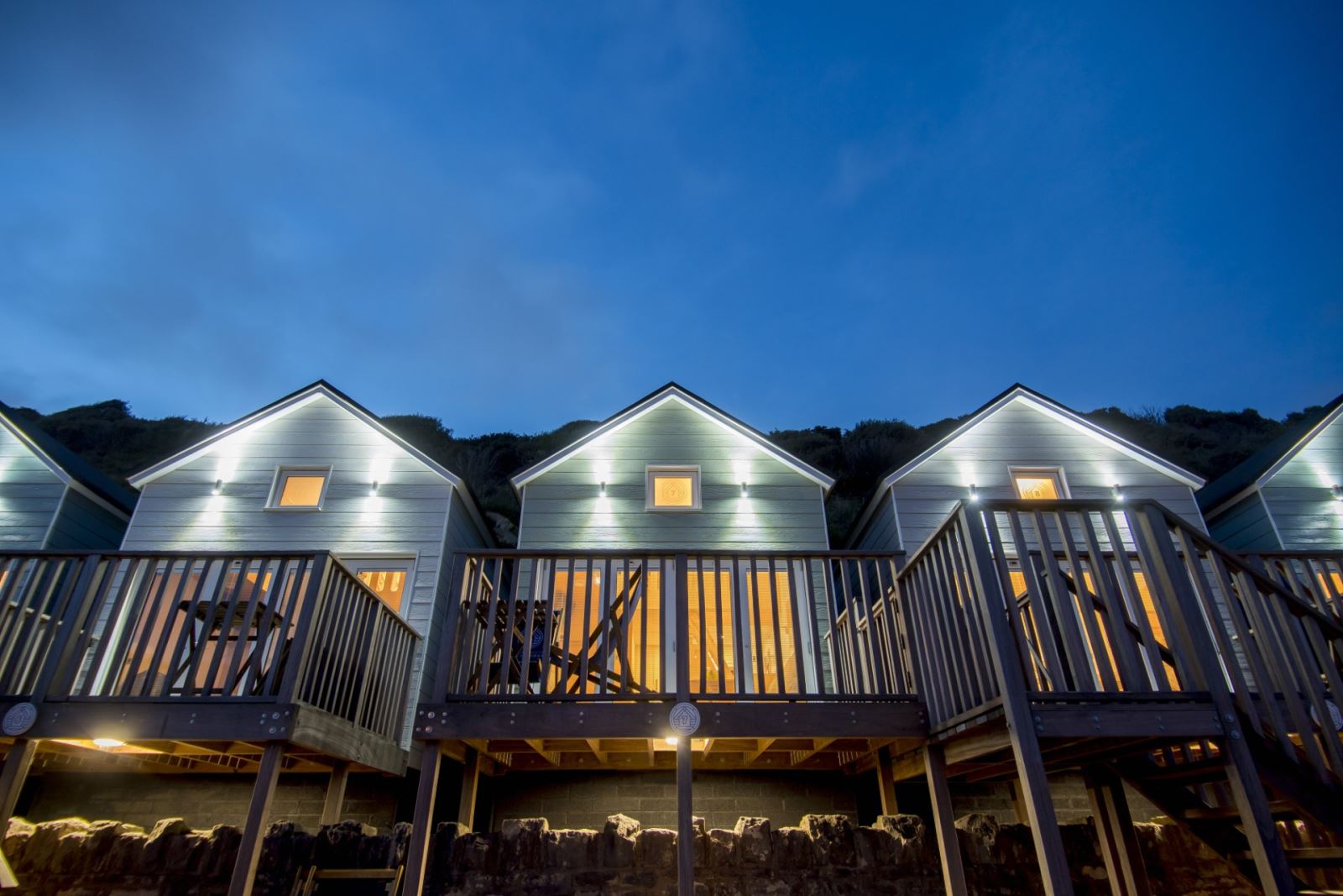 An evening view of the Bournemouth Beach Lodges, illuminated in the low Winter light.