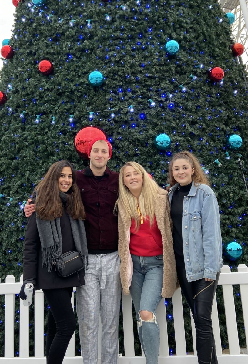 Three ladies and a man standing underneath the Moscow tree at the beginning of the 2019 Christmas Tree Wonderland trail.