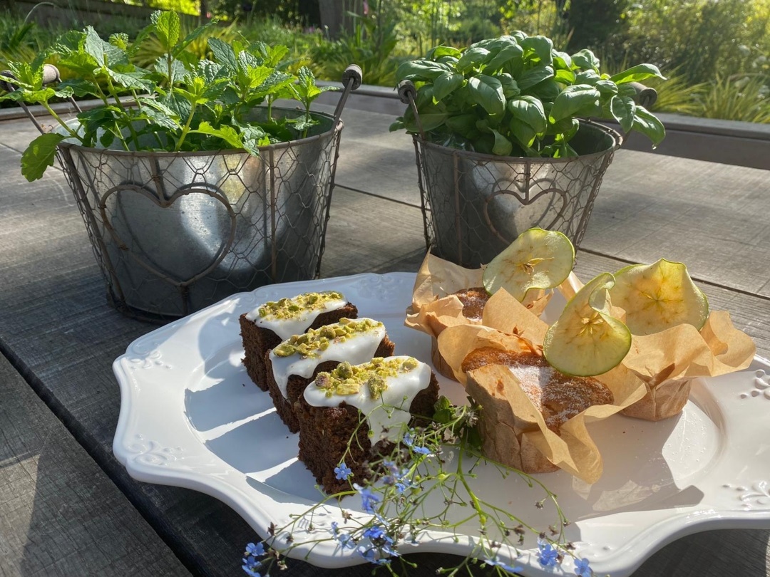 Two metallic pots of herbs, behind two silver platters of freshly baked apple and ginger cake from The Hotel Collingwood in Bournemouth