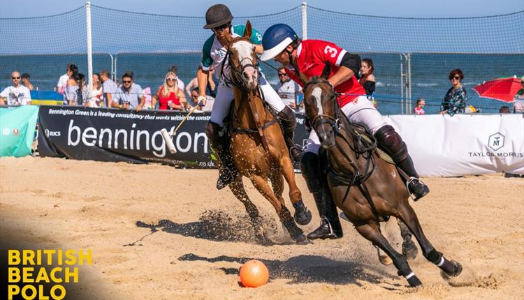 An image of two jockeys contesting the ball at SandPolo on the beautiful sandy and sunny SandBanks beach.