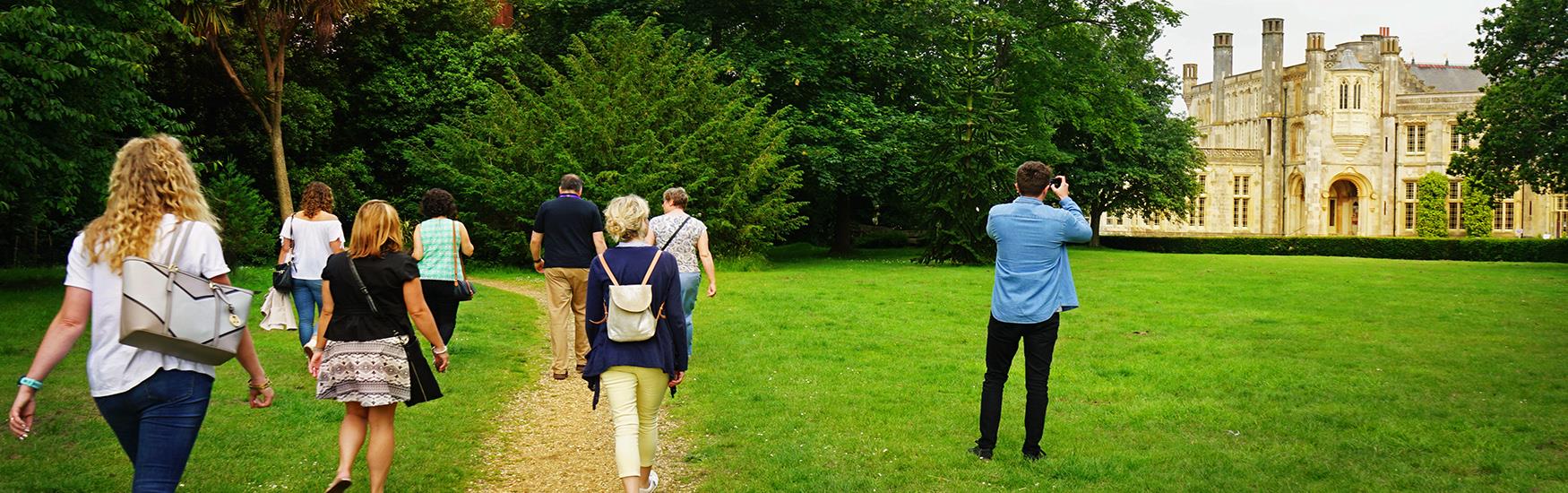Group exploring and taking photos of highcliffe castle in Christchurch