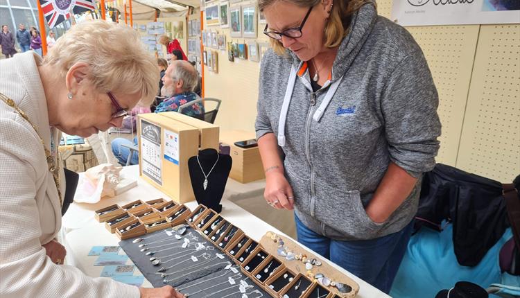 Woman looking at jewelery pop up store