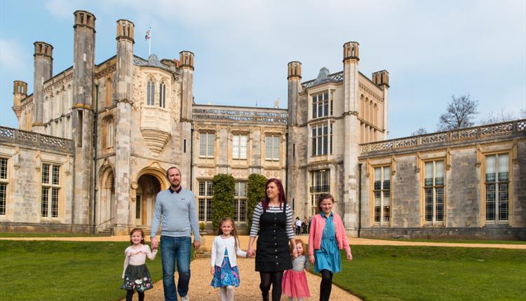 Family walking hand in hand outside of Castle