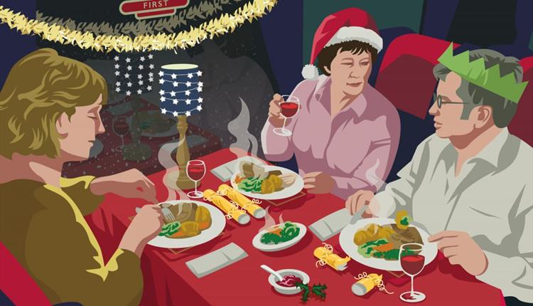 Family sitting around a table with food and Christmas decorations