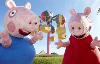 Peppa Pig and her brother pig having fun at Peppa Pig world