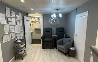 Grey interior with bright white lighting and a fashionable clock on the wall.