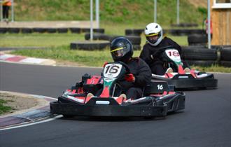 Two people raceing each other in go karts