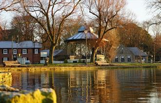Shot of the quay from the Bournemouth side of the river showing the bandstand and old mill in background.