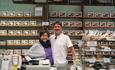 Two Burley Fudge employee's standing behind the counter