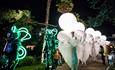 People dressed up for the arts festival in Bournemouths lower gardens at night