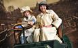 Two people dressed up on the first ever car