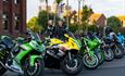Green and yellow sport motorbikes parked up