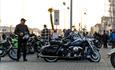 Man stands next to his chopper bike