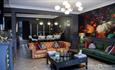 Image of a dark sitting area, which has a rich, glamour aesthetic