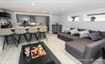 Grey lounge, with small bar in corner