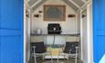 Beach hut with two chair and blue doors