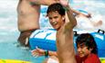 Two boys in pool waving