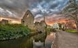 The Norman House photographed with a wide angle during a cloudy sunset.