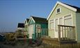 Green shade of beach huts facing left.