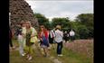 people gathering around the priory ruins to see the flowers