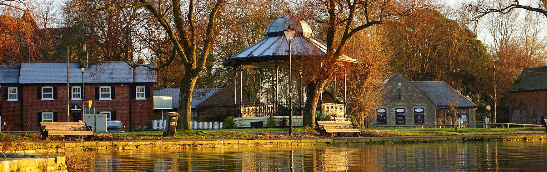 Autumnal scenes surround the Christchurch bandstand next to the quay