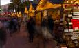 Crowds of people browsing the Christmas market stalls as they walk up Bournemouth high street