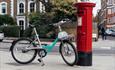 Beryl bike standing at a post box