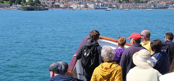 People looking towards the coast on a boat 