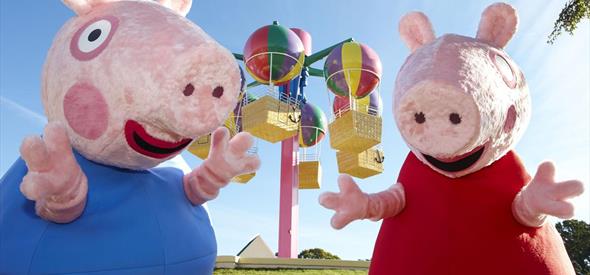 Peppa Pig and her brother pig having fun at Peppa Pig world