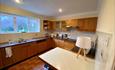 Large kitchen with table and wooden furnishings