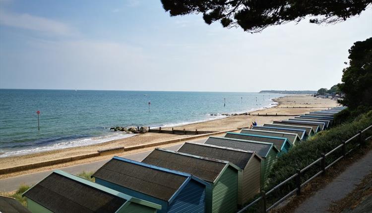 Friars Cliff Beach Huts view west towards Mudeford and Bournemouth.