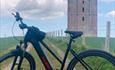 Black bike with a tower in the background