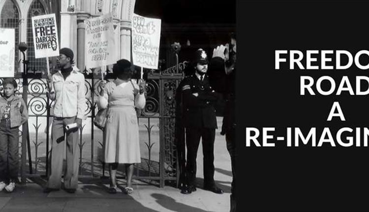 Black and White image of people protesting outside a fence.