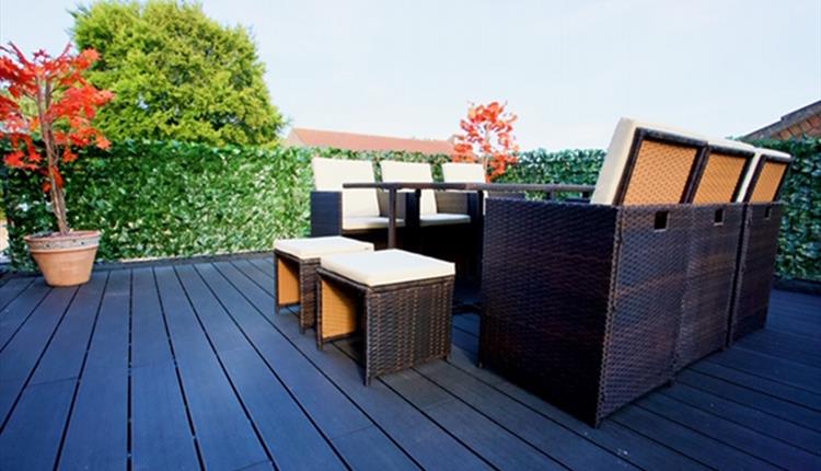 Outdoor seating area with wooden flooring