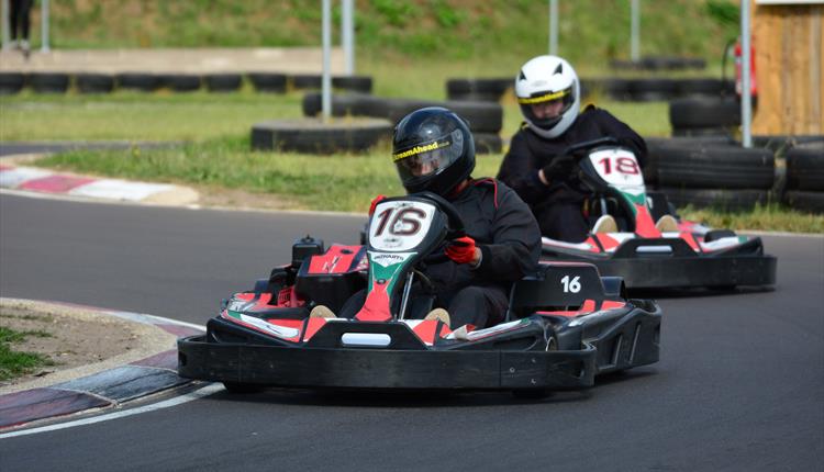 Two people raceing each other in go karts