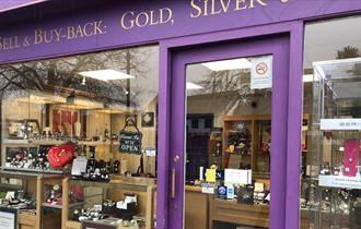 THE REIGN JEWELLERS AND WATCHES purple shop front