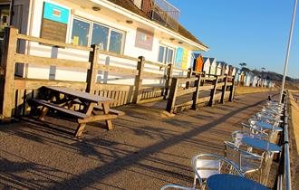 Beach hut cafe in the bright sunlight.