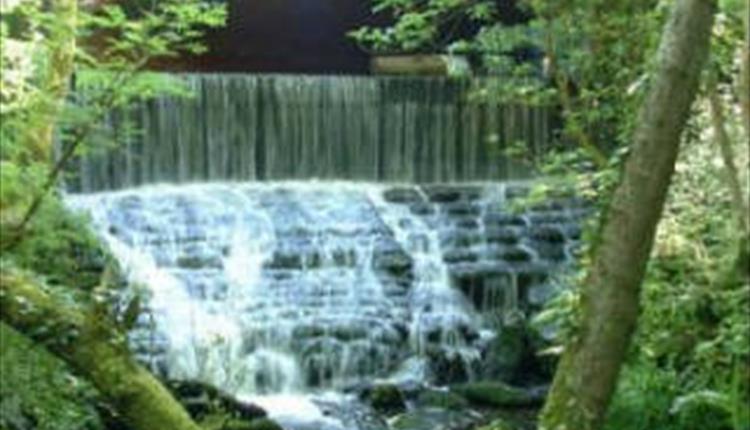 A bridge over cascading river at Chewton Bunny.