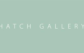 Hatch Gallery white text on green logo book-ended by martini glasses.